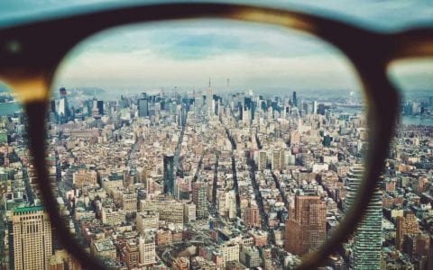 A shot of new york city viewed through the lens of a pair of glasses